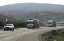 A convoy formed by a delegation of United Nations High Commissioner for Refugees and Syrian Arab Red Crescent carry humanitarian aid as they drive in Aleppo's countryside